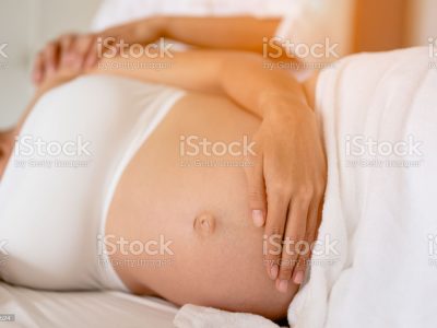 Pregnant women are enjoying a relaxing massage in bed at home. To treat and care for the mental health of the fetus Prenatal and Pregnancy Care Concept of Women